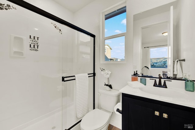 bathroom featuring wood-type flooring, vanity, toilet, and walk in shower