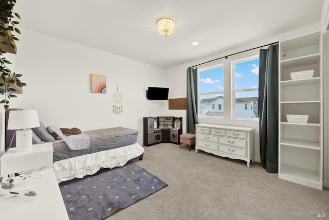 bedroom featuring light carpet