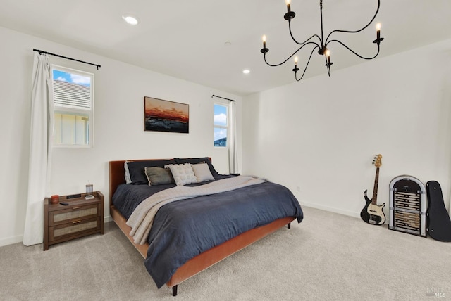 bedroom featuring a notable chandelier and light carpet