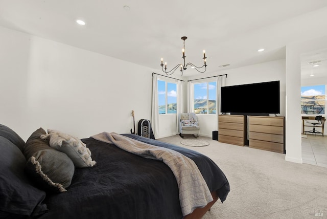 bedroom featuring light colored carpet and an inviting chandelier