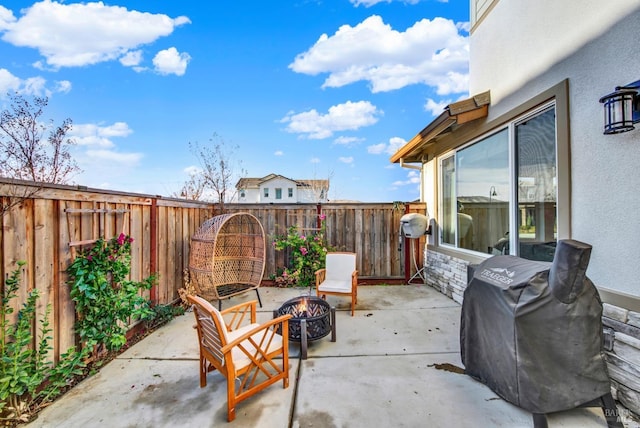 view of patio featuring a grill and an outdoor fire pit