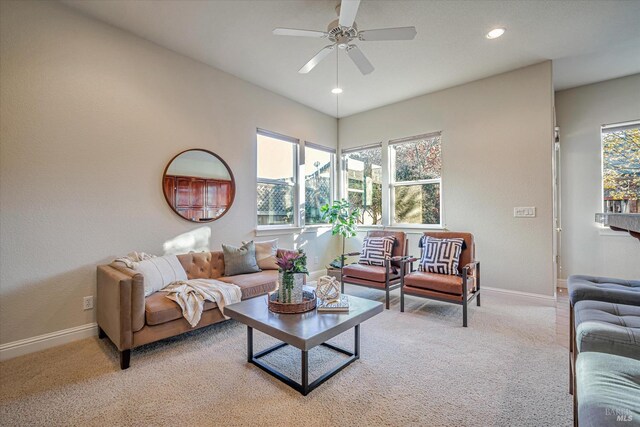 carpeted living room featuring ceiling fan