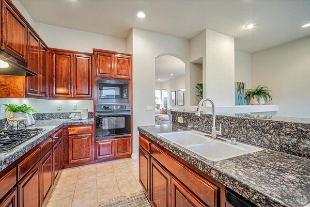 kitchen with black appliances, light tile patterned floors, and sink