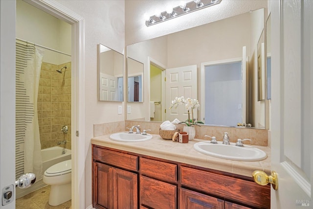 full bathroom with toilet, vanity, tile patterned flooring, and shower / bath combo with shower curtain