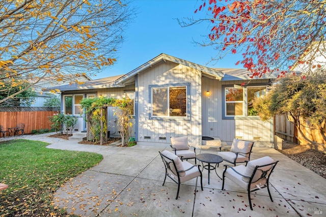 rear view of property featuring a patio