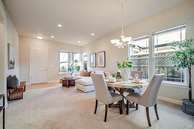 carpeted dining space with plenty of natural light and a notable chandelier