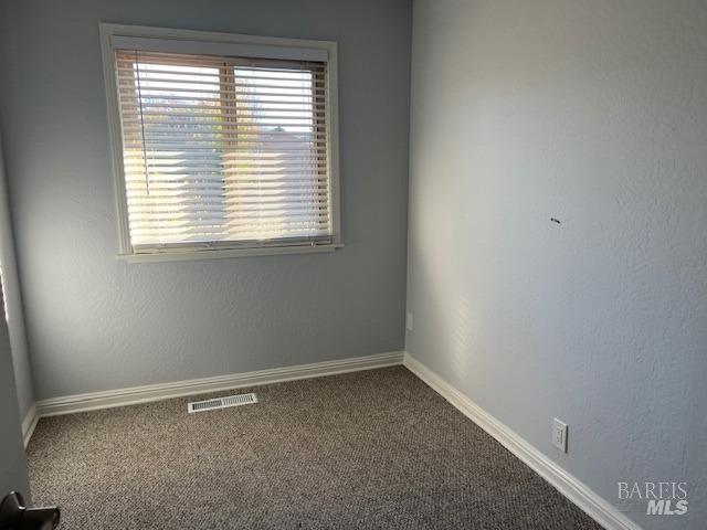 unfurnished room featuring carpet floors