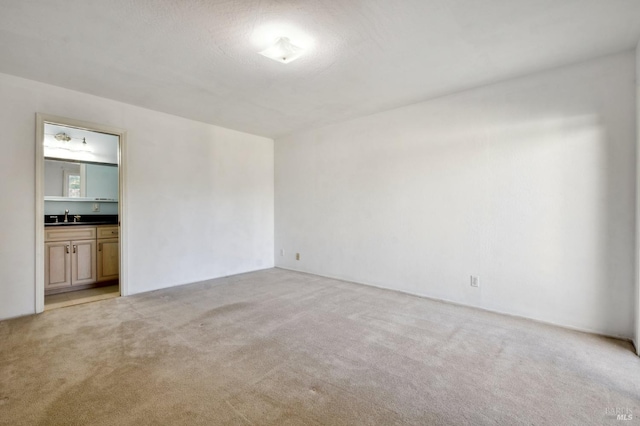 carpeted empty room featuring sink