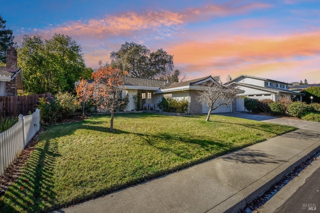 view of front of house featuring a lawn and a garage