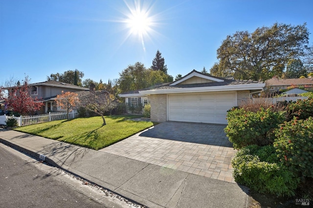 ranch-style house featuring a garage and a front lawn