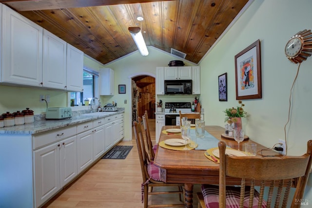 dining area with arched walkways, visible vents, light wood-style floors, vaulted ceiling, and wooden ceiling