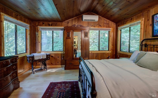 bedroom with a wall mounted AC, vaulted ceiling, wood walls, light wood-type flooring, and wooden ceiling