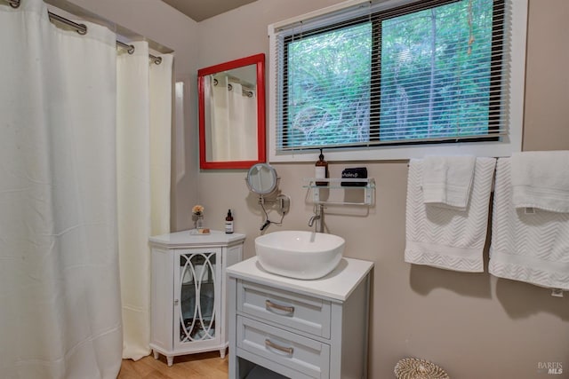 full bath featuring wood finished floors and vanity