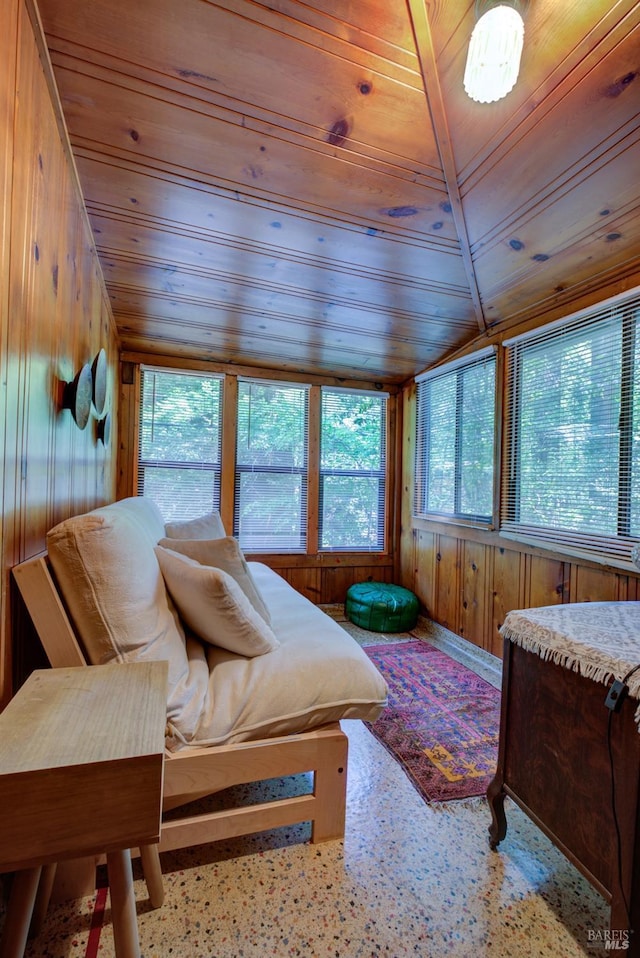 bedroom with vaulted ceiling, wood walls, and wood ceiling