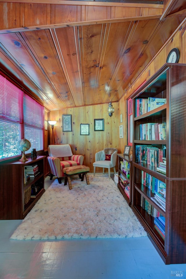 sitting room with wood ceiling and wooden walls