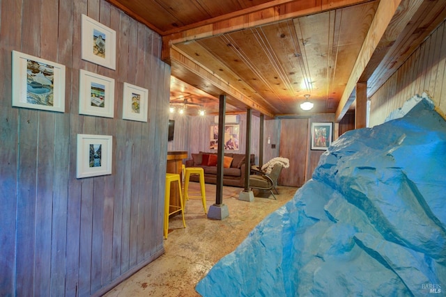 bedroom with wooden ceiling and wood walls