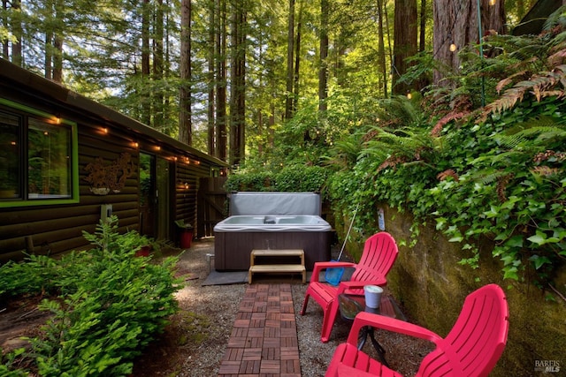 view of patio / terrace with a hot tub