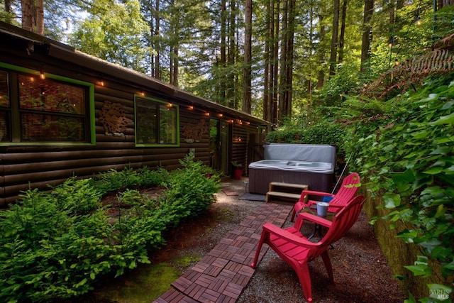 view of patio / terrace with a hot tub