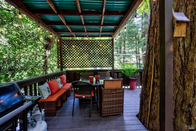 wooden terrace with an outdoor hangout area and outdoor dining area