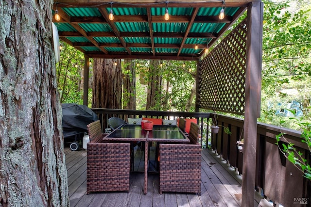 wooden terrace featuring outdoor dining area