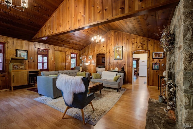 living area with wooden ceiling, arched walkways, a chandelier, and light wood finished floors