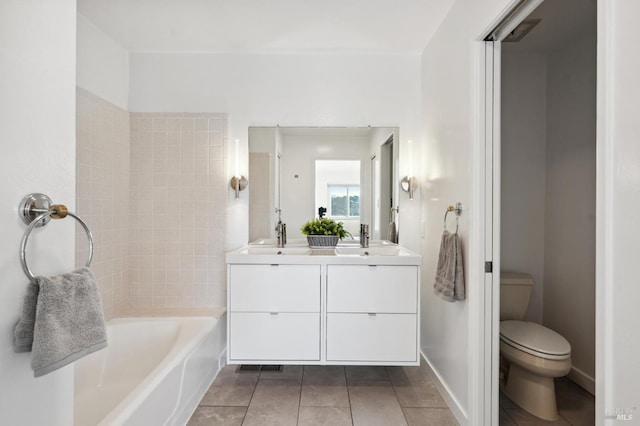 bathroom featuring tile patterned floors, vanity, and toilet