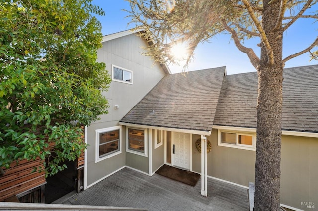 view of front of home with a shingled roof and stucco siding