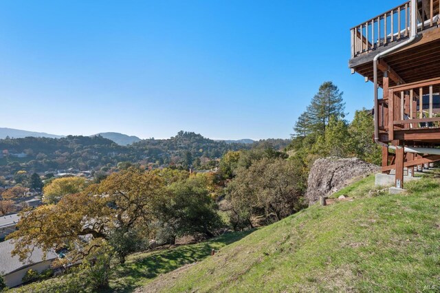 view of yard with a mountain view and a balcony