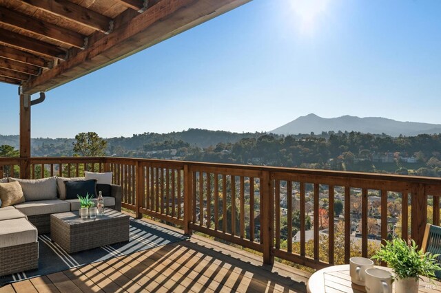 deck featuring outdoor lounge area and a mountain view