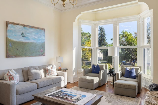 living room with hardwood / wood-style flooring, ornamental molding, and a wealth of natural light