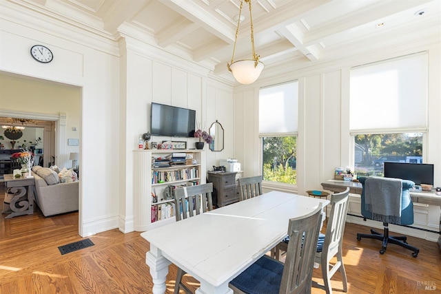 dining area featuring beam ceiling, wood-type flooring, ornamental molding, and coffered ceiling