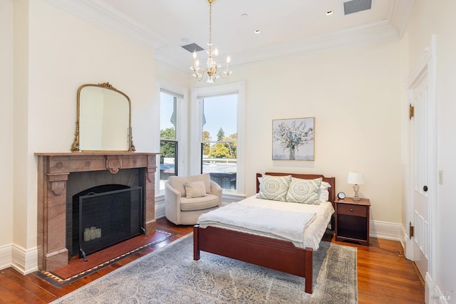 bedroom featuring dark hardwood / wood-style floors, crown molding, and an inviting chandelier