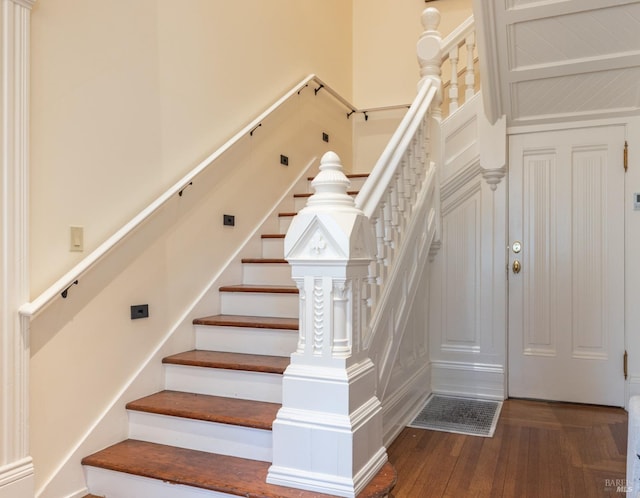 stairway featuring wood-type flooring