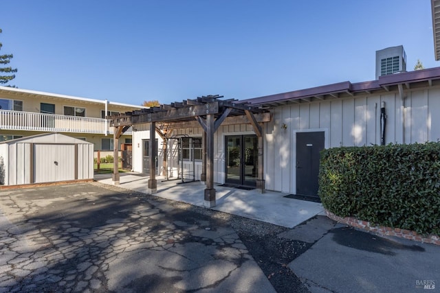 exterior space featuring a storage unit, a pergola, and a patio