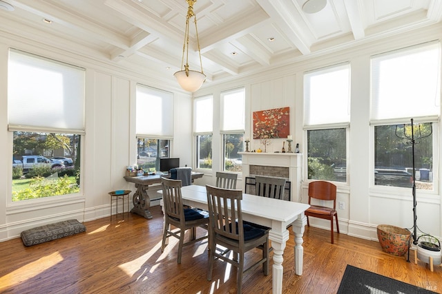 sunroom / solarium with beamed ceiling, a healthy amount of sunlight, and coffered ceiling