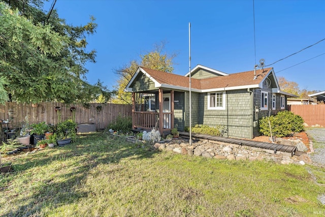 view of front facade with fence private yard and a front yard