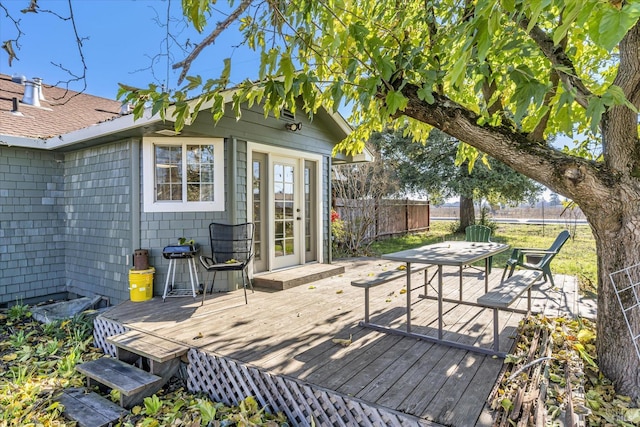 wooden deck with outdoor dining space and fence