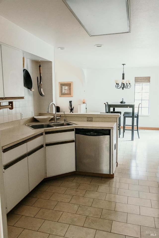 kitchen with white cabinetry, dishwasher, sink, pendant lighting, and light tile patterned floors