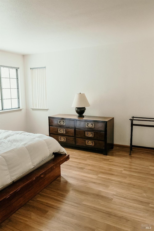 bedroom with light wood-type flooring