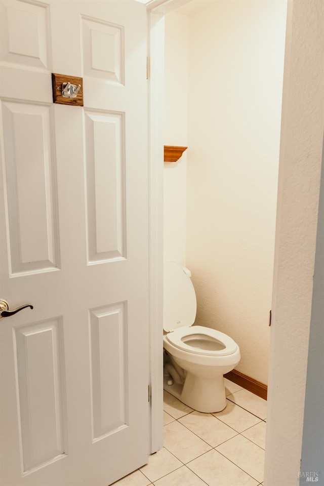 bathroom with tile patterned floors and toilet