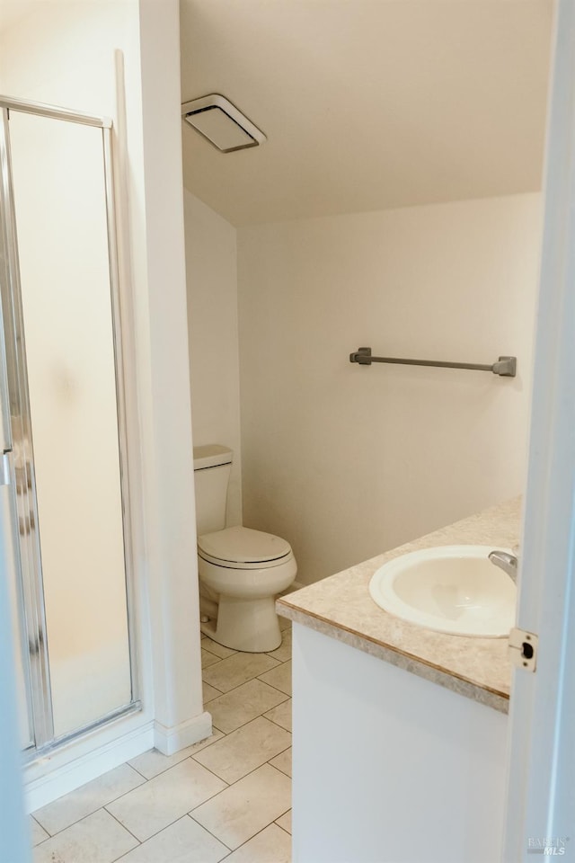 bathroom featuring tile patterned floors, vanity, toilet, and walk in shower