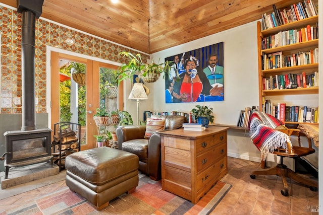 sitting room featuring a wood stove and wood ceiling