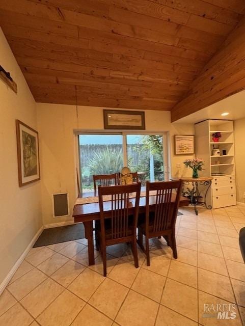 dining room with lofted ceiling, wooden ceiling, and light tile patterned floors