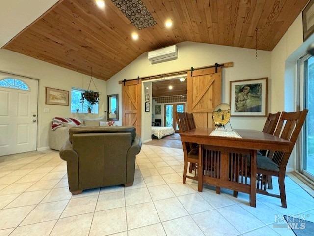 tiled living room with lofted ceiling, a barn door, a wall mounted AC, and wooden ceiling