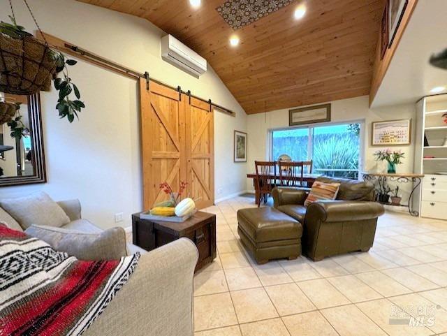 living room with a wall mounted air conditioner, wood ceiling, a barn door, high vaulted ceiling, and light tile patterned flooring