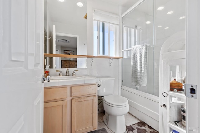 full bathroom with tile patterned floors, toilet, vanity, and combined bath / shower with glass door