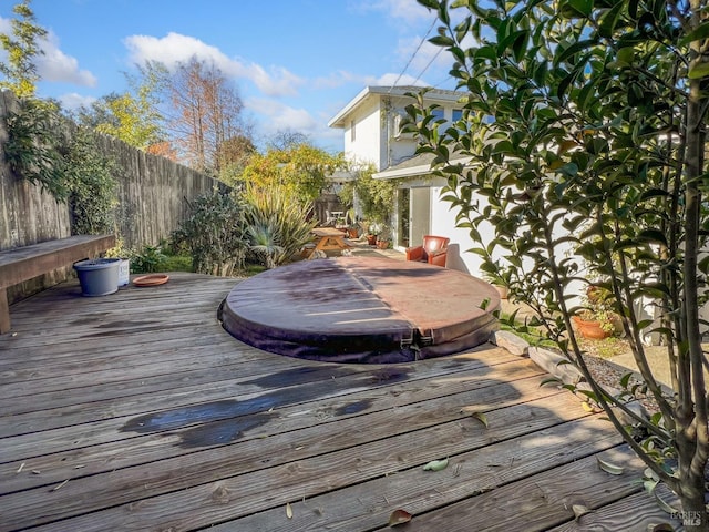 wooden terrace featuring a covered hot tub