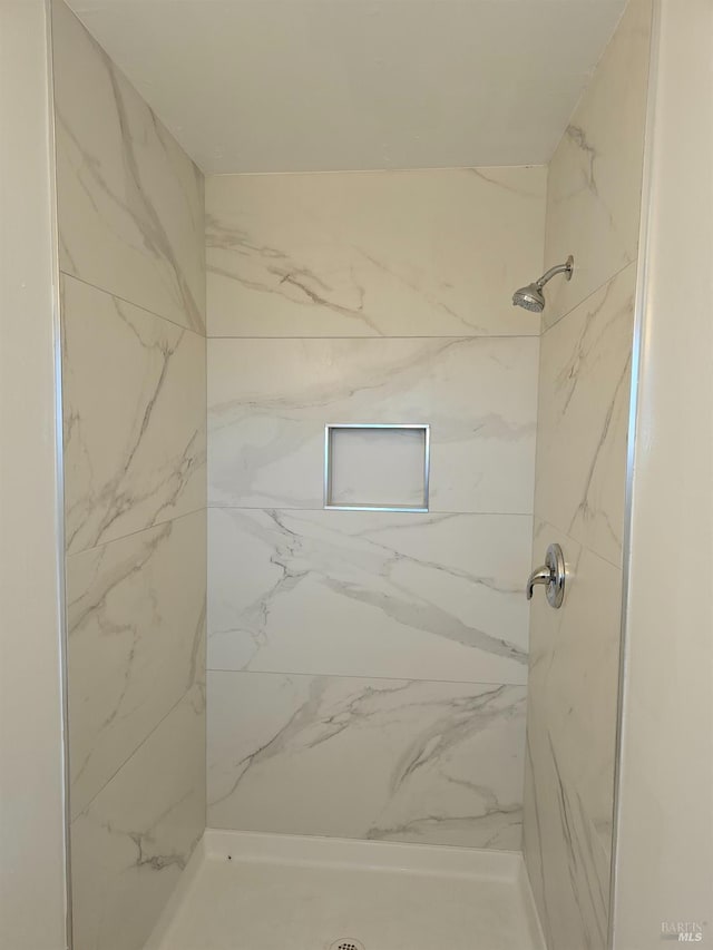 bathroom with a tile shower