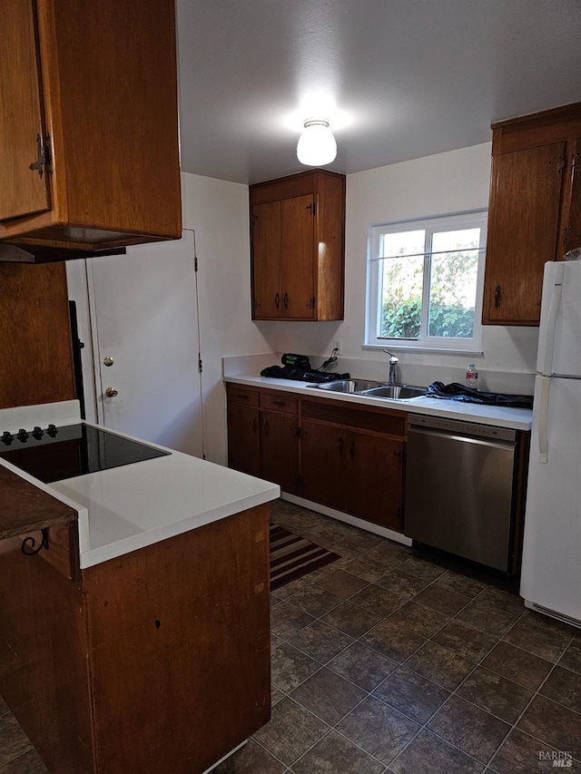 kitchen featuring sink, stainless steel dishwasher, white fridge, stovetop, and kitchen peninsula