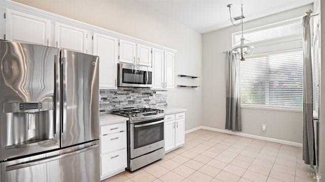 kitchen featuring pendant lighting, white cabinets, stainless steel appliances, and light tile patterned floors